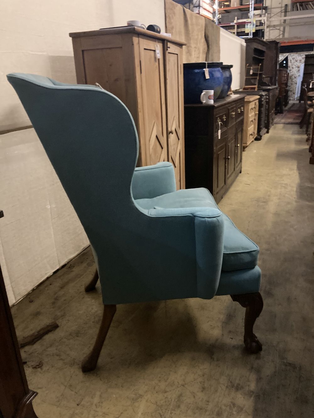 A George III design upholstered wing armchair, width 86cm, depth 80cm, height 110cm